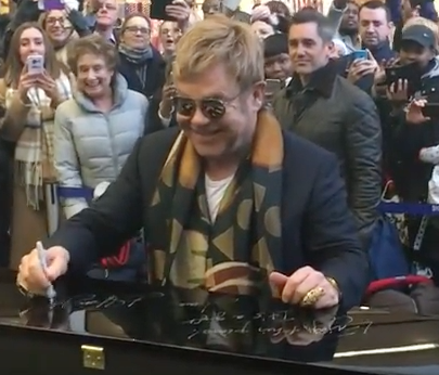 John signing the Yamaha piano which he donated to the station