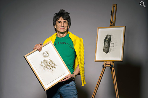 Ronnie Wood holds a drawing from his 1965 diary (Photo from the Genesis Publications website)
